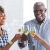 a few people toasting wine glasses